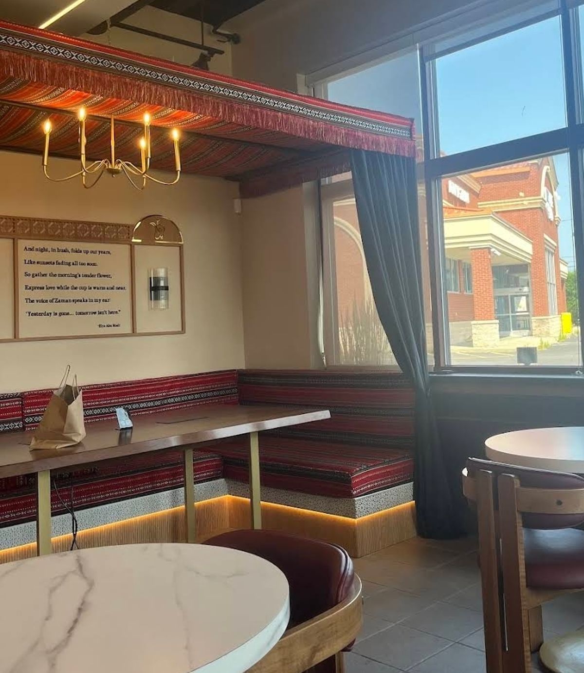 Majlis-style coffee shop booth with Arabic poetry