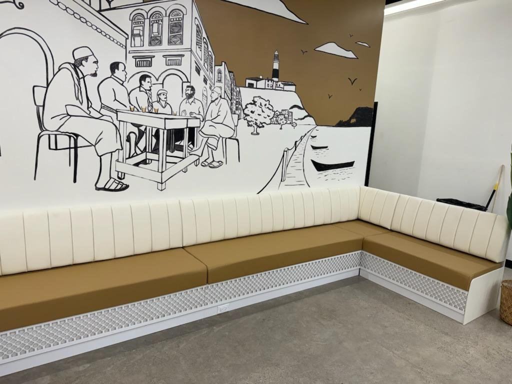 Coffee shop charcoal channel-tufted seating with hex table